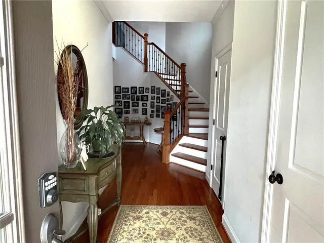 a kitchen with granite countertop a refrigerator and a stove top oven