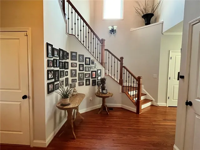 a kitchen with stainless steel appliances kitchen island granite countertop a table chairs and a refrigerator