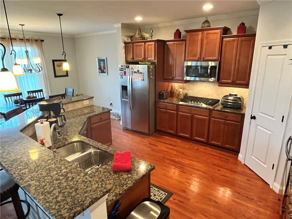 307 Cornerstone Trace Woodstock, GA 30188 - Photo 8 of 43 a kitchen with stainless steel appliances granite countertop a refrigerator a stove and a sink