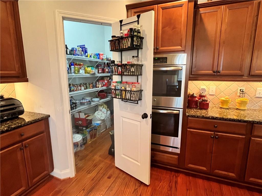 307 Cornerstone Trace Woodstock, GA 30188 - Photo 10 of 43 a kitchen with stainless steel appliances a refrigerator and a stove top oven