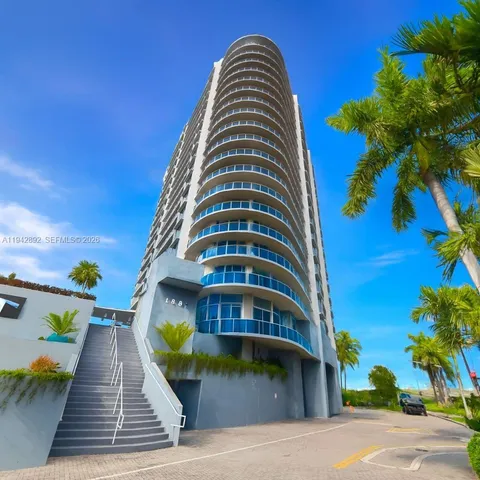 a tall building with trees in front of it