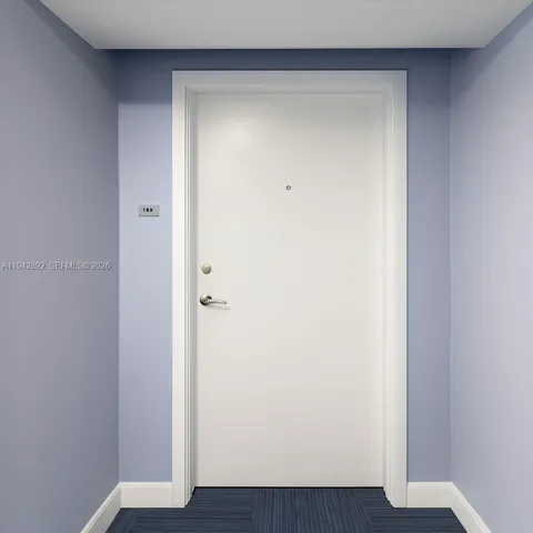a view of a livingroom with a floor to ceiling window and wooden floor