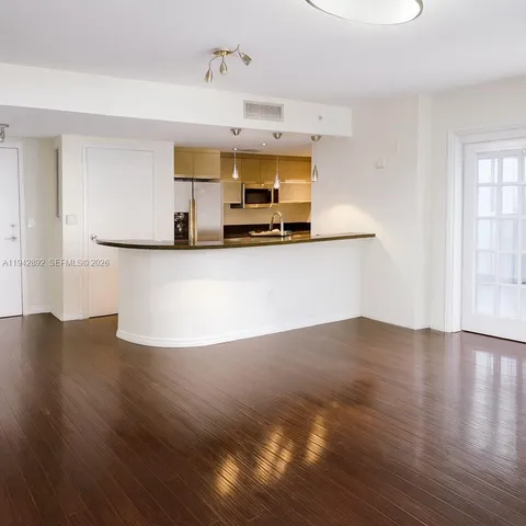 a kitchen with granite countertop wooden floors and stainless steel appliances