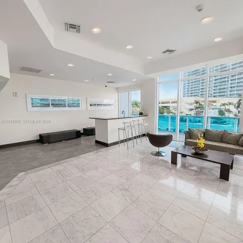 a bedroom with furniture and large windows