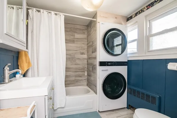 a bathroom with a sink a mirror a bathtub and a sink