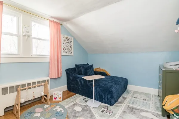 a bedroom with furniture and a window