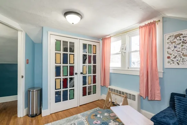 a bedroom with furniture and a book shelf