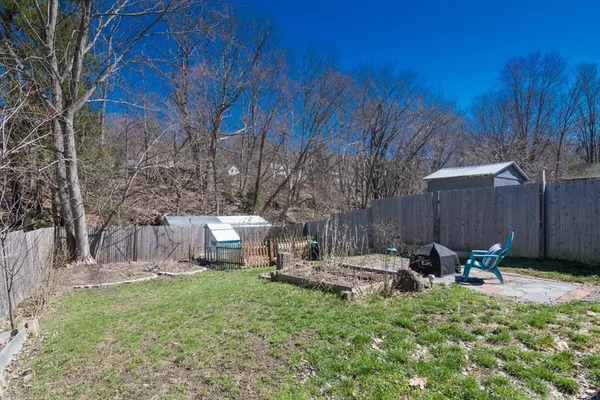 a backyard of a house with table and chairs