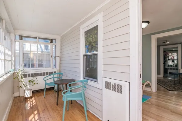 a view of a living room and a window with wooden floor