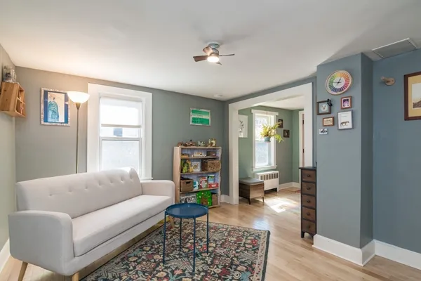 a living room with furniture and a wooden floor