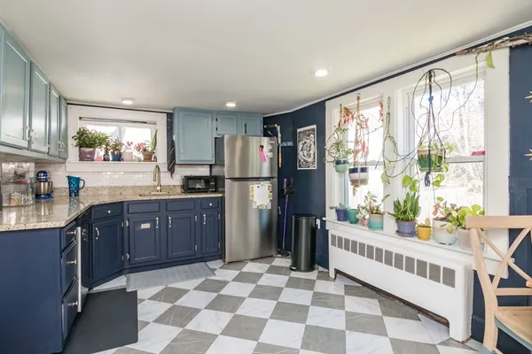 a kitchen with stainless steel appliances granite countertop a refrigerator and a sink
