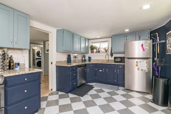 a kitchen with a refrigerator and cabinets