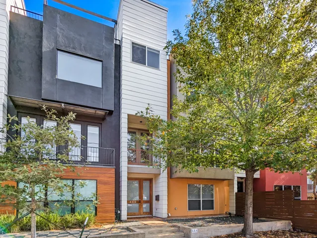 a front view of a building with trees