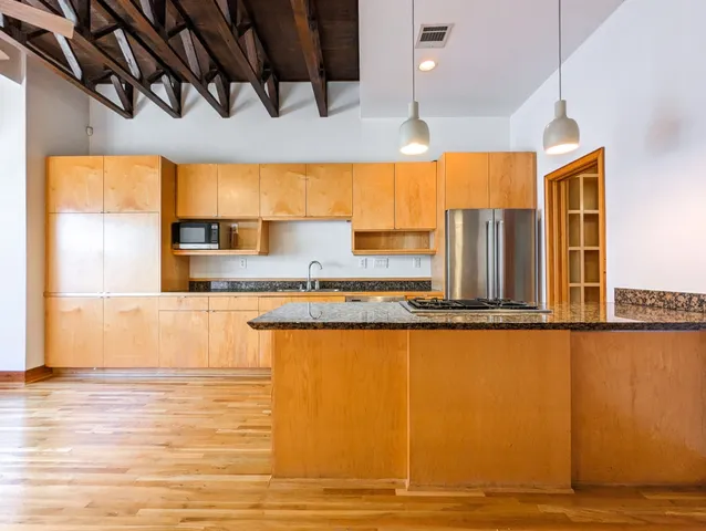 a kitchen with stainless steel appliances granite countertop a sink and cabinets