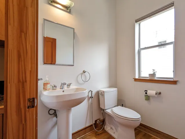 a bathroom with a sink toilet and a mirror