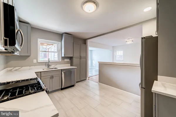 a kitchen with a sink stove and refrigerator