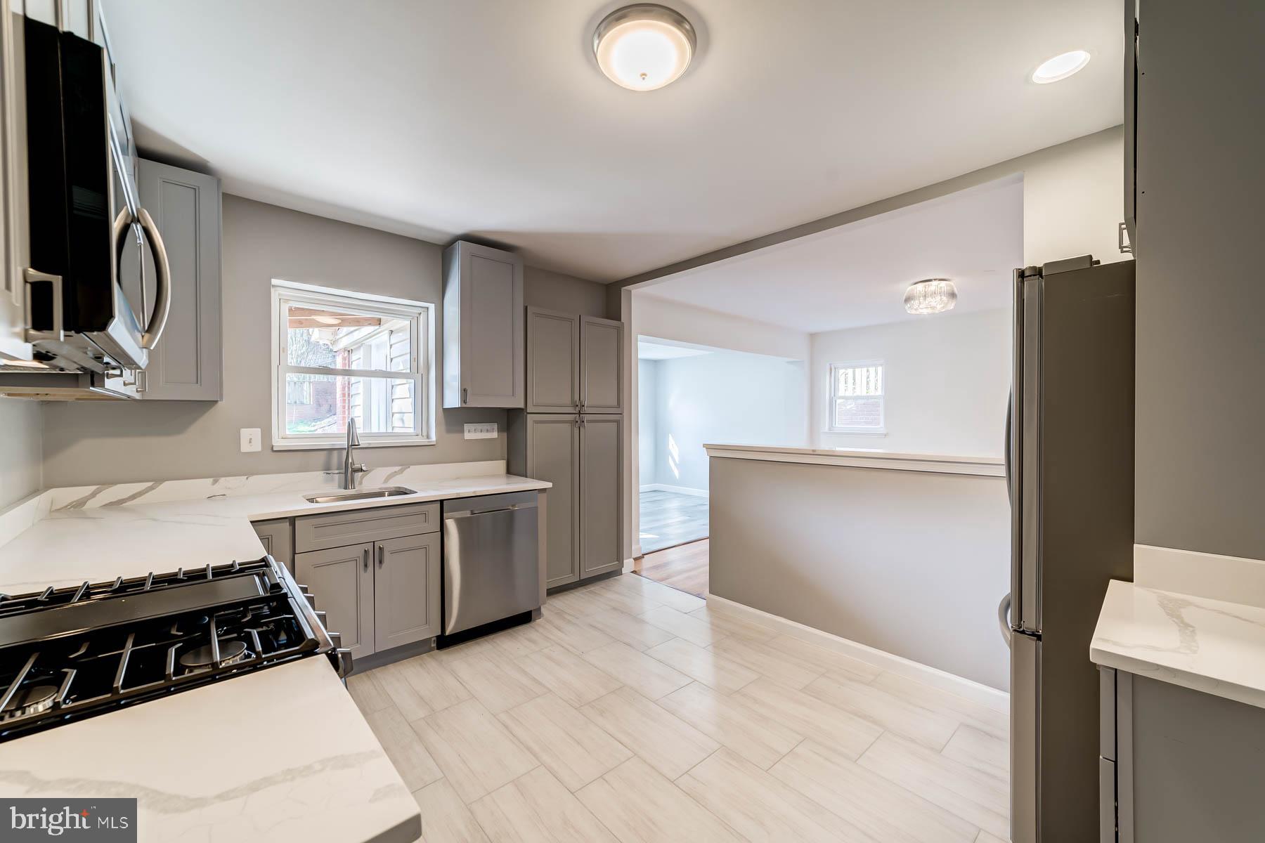 2608 Rittenhouse Street Northwest Washington, DC 20015 - Photo 13 of 45 a kitchen with a sink stove and refrigerator