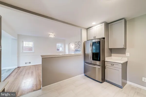a kitchen with stainless steel appliances a refrigerator and a stove top oven