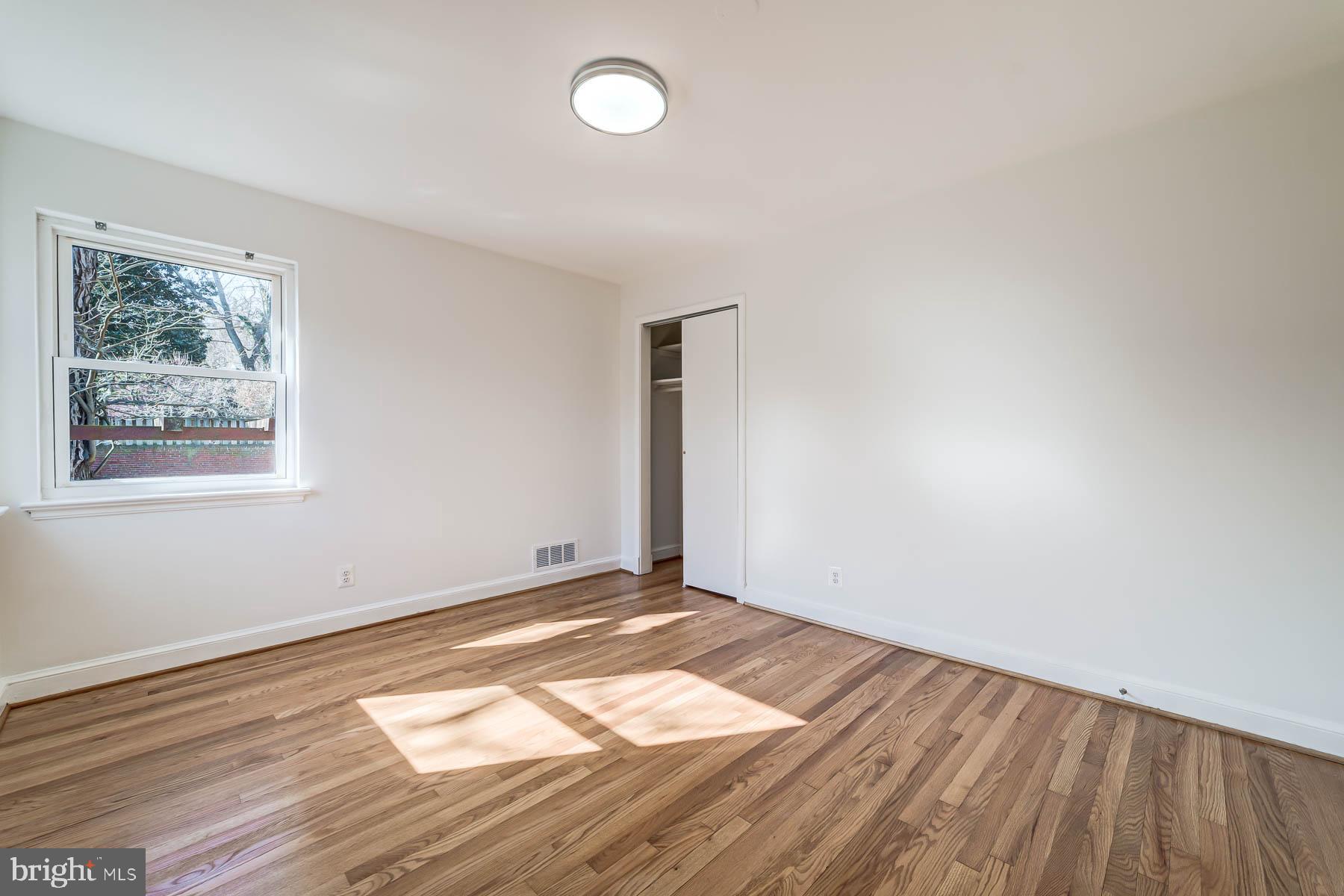 2608 Rittenhouse Street Northwest Washington, DC 20015 - Photo 20 of 45 a view of an empty room with wooden floor and a window