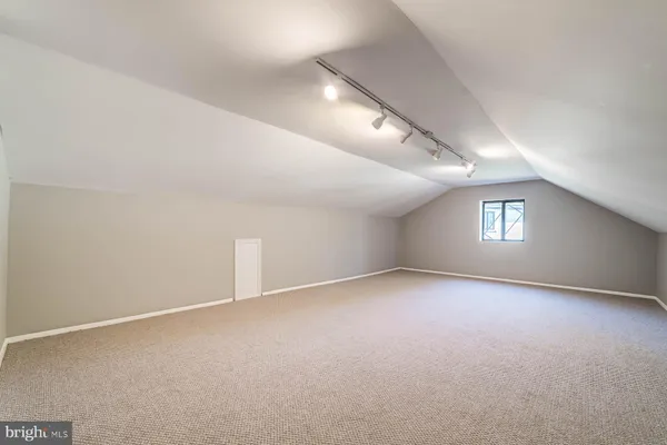 an empty room with a window and a ceiling fan