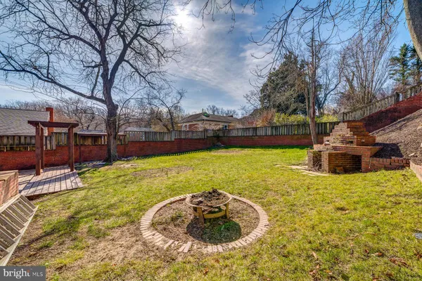 a swimming pool with outdoor seating and yard