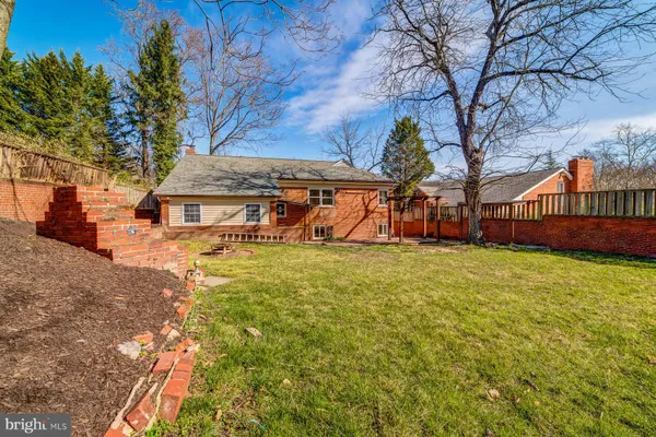 a view of a house with a yard and sitting area