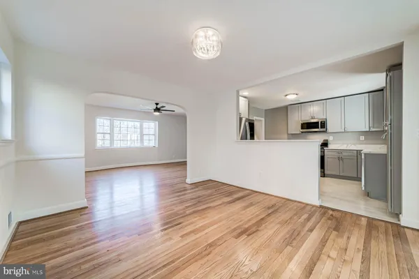 a view of a kitchen with wooden floor and a window