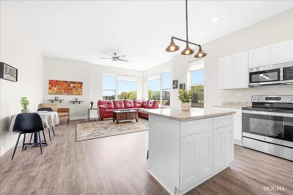 a kitchen with stainless steel appliances granite countertop a stove a sink and a refrigerator