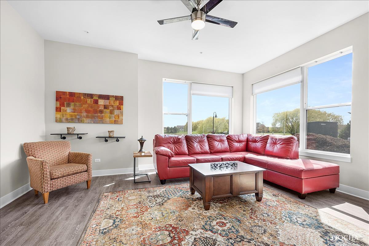 1101 Ritter Street, Unit 303 North Aurora, IL 60542 - Photo 5 of 11 a living room with furniture and a large window