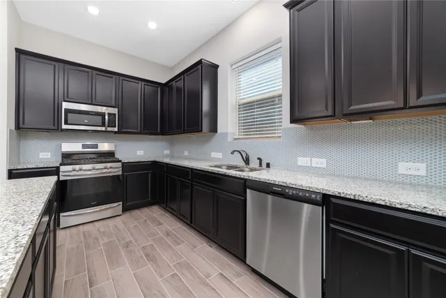 a kitchen with granite countertop wooden cabinets a stove top oven and granite counter tops