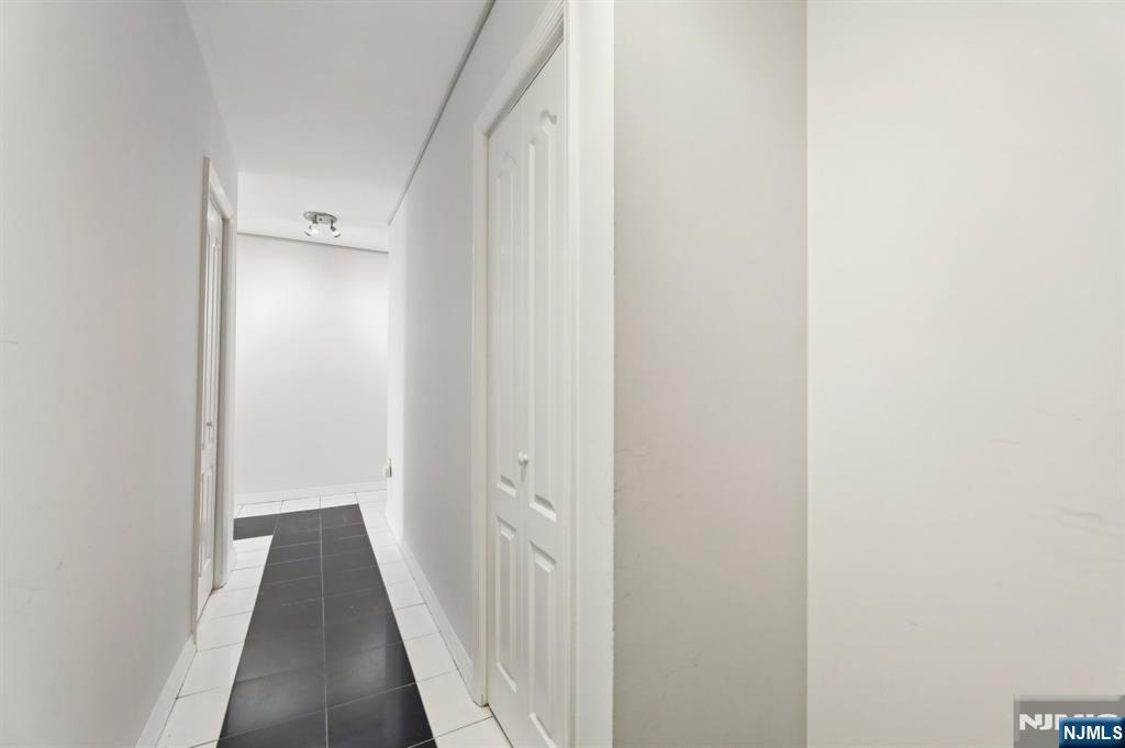 151 Prospect Avenue, Unit 18A Hackensack, NJ 07601 - Photo 13 of 19 a view of a hallway with wooden floor