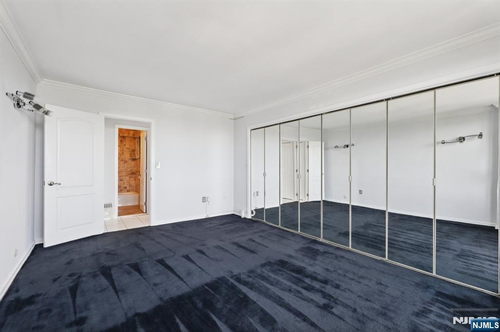 151 Prospect Avenue, Unit 18A Hackensack, NJ 07601 - Photo 15 of 19 a view of empty room with wooden floor and fan