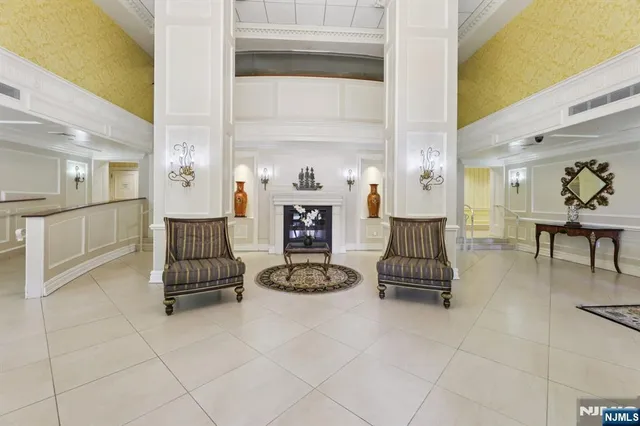 a living room with furniture a dining table and a fireplace