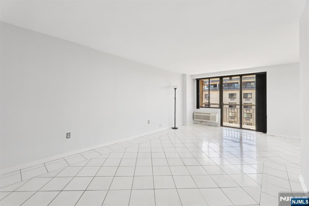 151 Prospect Avenue, Unit 18A Hackensack, NJ 07601 - Photo 5 of 19 a view of an empty room with a window
