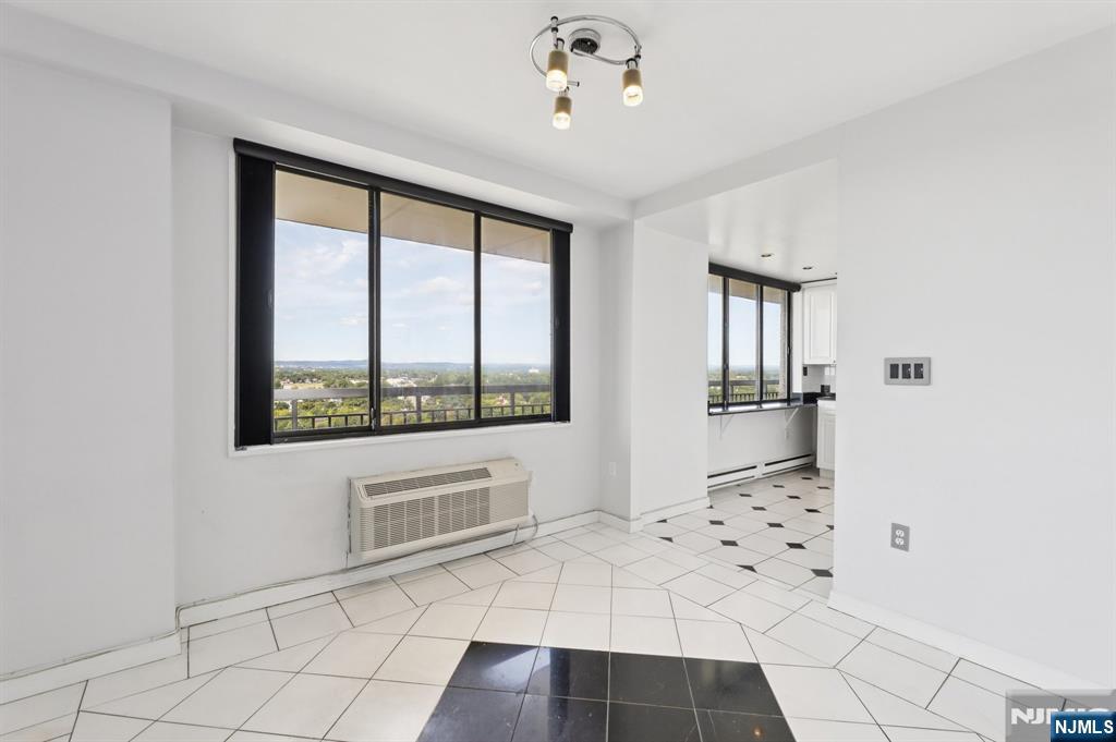 151 Prospect Avenue, Unit 18A Hackensack, NJ 07601 - Photo 10 of 19 a view of a livingroom with wooden floor and a kitchen