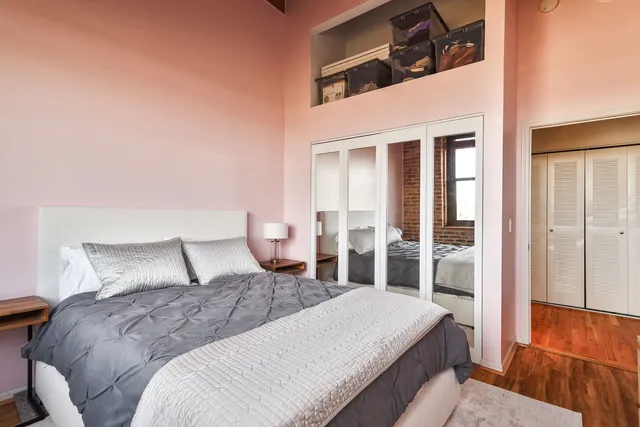 a bedroom with a bed and glass door