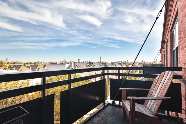 a view of a chairs and table in the balcony