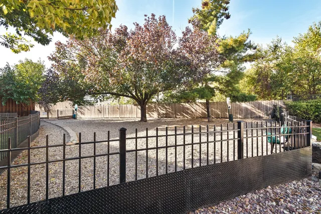 a view of a white house with a street