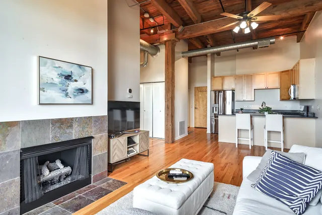 a living room with furniture and a fireplace
