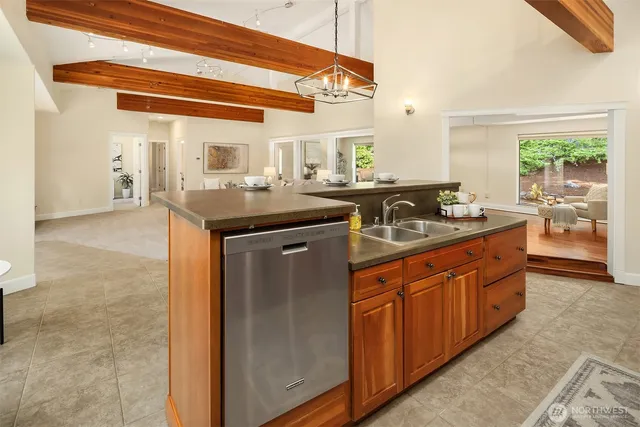 a kitchen with stainless steel appliances granite countertop a sink and a stove