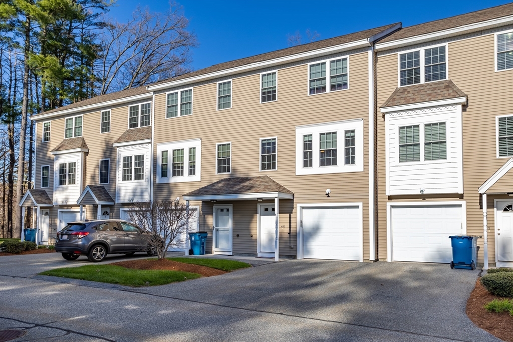 a front view of a residential apartment building with a yard