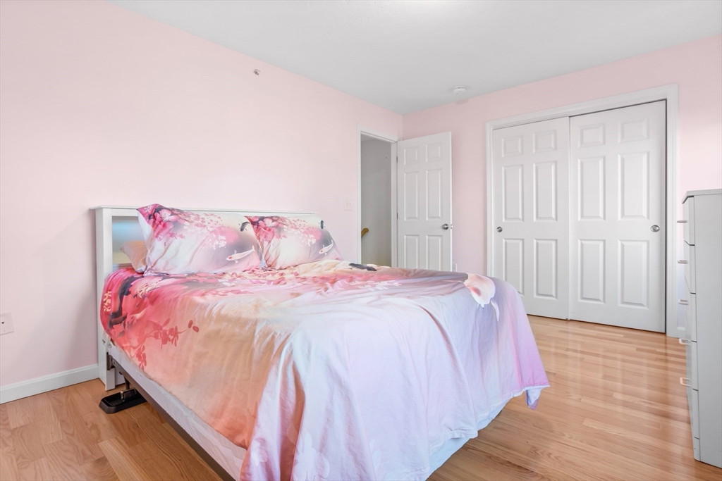 41 Boston Road, Unit 433 Billerica, MA 01862 - Photo 11 of 23 a bedroom with a bed and a mirror