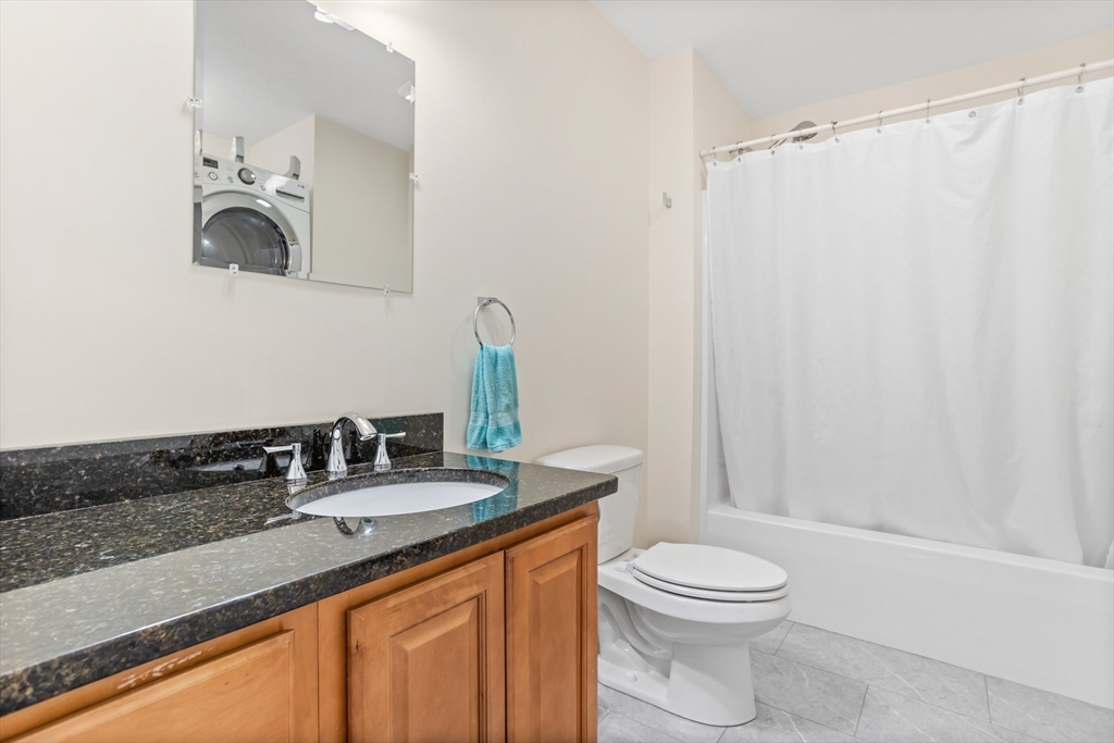 41 Boston Road, Unit 433 Billerica, MA 01862 - Photo 14 of 23 a bathroom with a granite countertop sink toilet and shower
