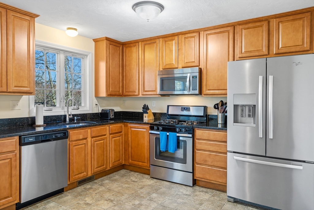 41 Boston Road, Unit 433 Billerica, MA 01862 - Photo 5 of 23 a kitchen with stainless steel appliances granite countertop a refrigerator stove microwave and sink