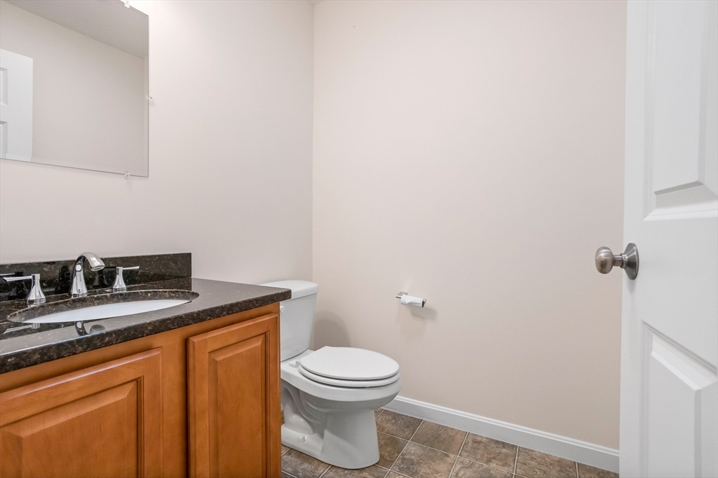 41 Boston Road, Unit 433 Billerica, MA 01862 - Photo 10 of 23 a bathroom with a granite countertop toilet and a sink