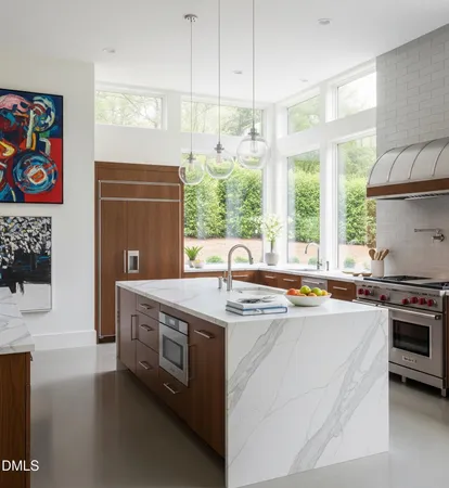 a kitchen with stainless steel appliances granite countertop a stove a sink and a refrigerator
