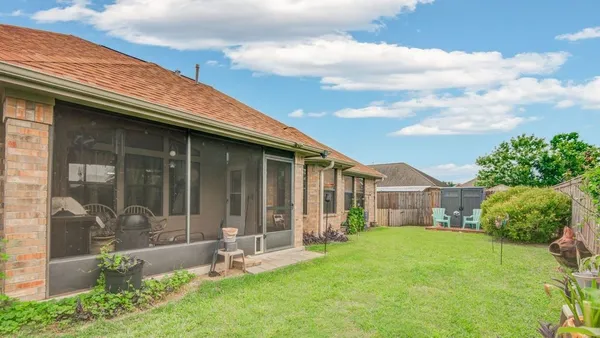 a backyard of a house with table and chairs