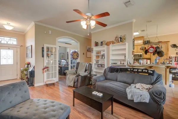 a living room with furniture and kitchen view