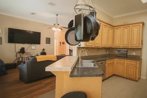 a kitchen with a sink a stove and a wooden floors
