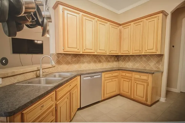 a kitchen with stainless steel appliances granite countertop a sink and a white cabinets